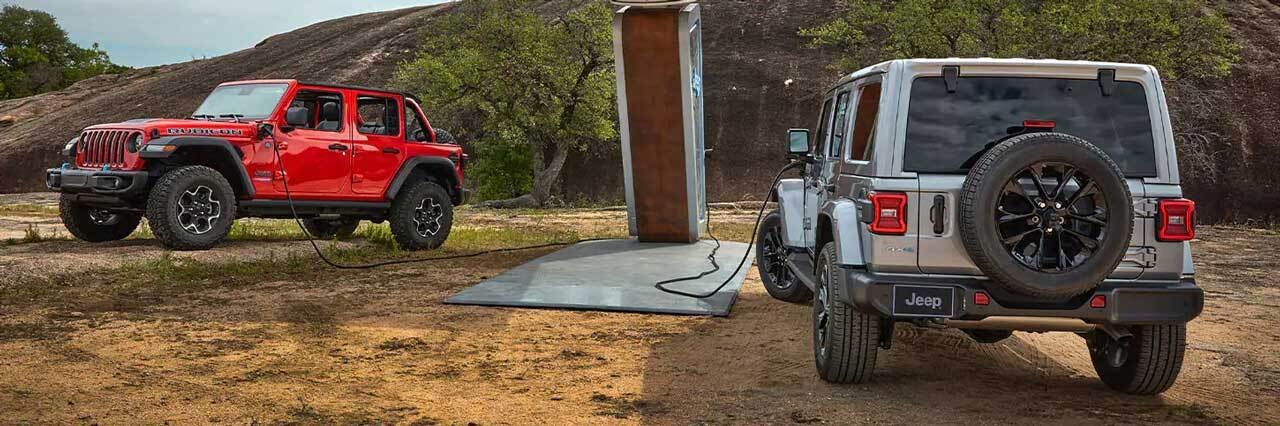Two Jeep Wranglers at a charging station
