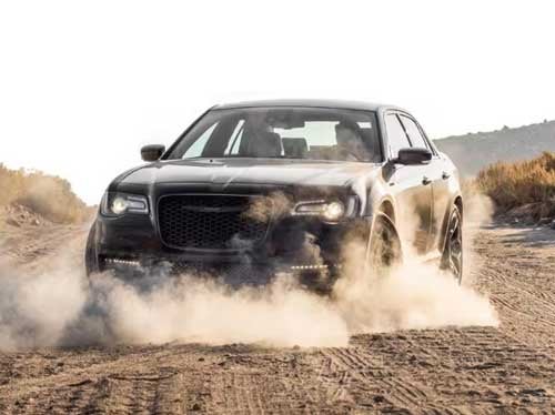 2023 Chrysler 300 driving surrounded by a dust cloud