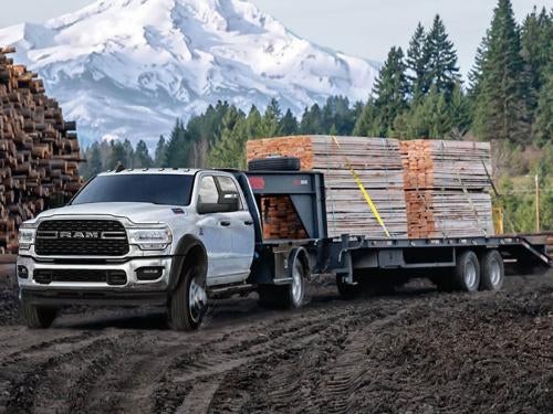 2023 RAM Chassis Cab towing a trailer of lumber